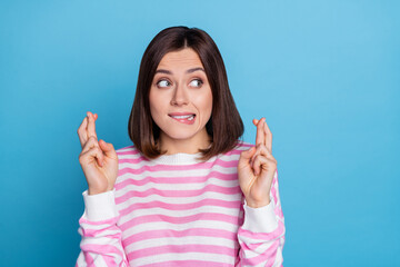 Photo of worried millennial bob hairdo lady crossed fingers wear striped shirt isolated on blue color background