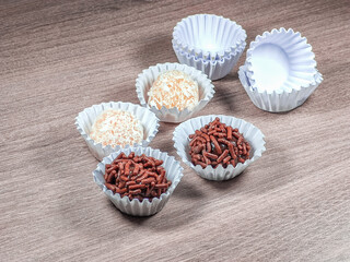 Tradicional Brazilian Snack Brigadeiro on a plate on a wooden background