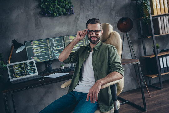 Photo of skilled nerd guy touch specs remote distance work java script write code platform optimization sit desk in workspace