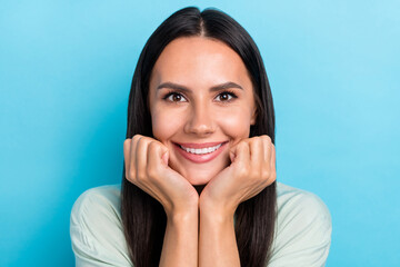 Photo of young adorable woman good mood hands touch cheeks dream isolated over blue color background