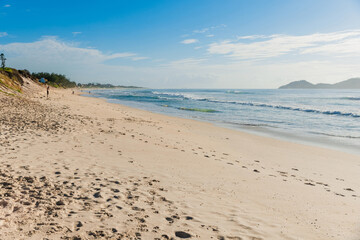 Holiday beach and ocean with waves in Brazil. Morro das Pedras beach in Florianopolis