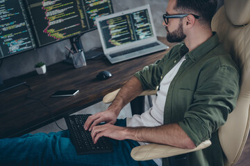Photo of positive busy young guy dressed khaki shirt glasses writing data software modern gadget...