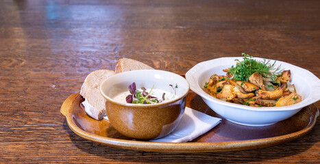 Bowl with mushrooms, sour cream and bread for menu in the restaurant, cafe or hotel Copy Space