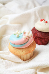 Vibrant cupcakes chocolate and red velvet with whipped vanilla cream on white background. Valentines day