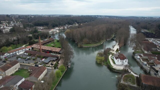 White mansion and hotel Quai along the Charente River in Cognac France, Aerial pedestal rising shot
