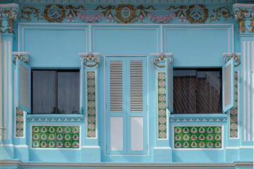 Straits Chinese Peranakan exterior with wooden louvers, rococo designs and floral mosaic tiles - obrazy, fototapety, plakaty