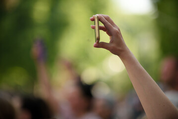 Selective focus shot of a person taking a photo with a smartphone