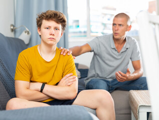 Obraz premium Father comforting his son who's in bad mood and feeling depressed.