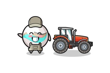 the marble toy farmer mascot standing beside a tractor