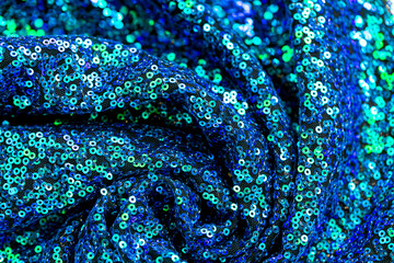  Sequins texture.Green blue sequins background.Shiny blue and green fabric. Weaving and embroidery...