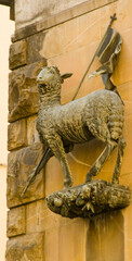 statue of lamb on a wall