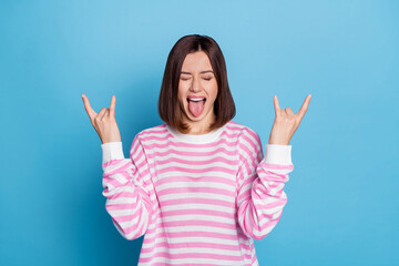 Photo of cool young brunette lady show rock sign wear sweater isolated on blue background
