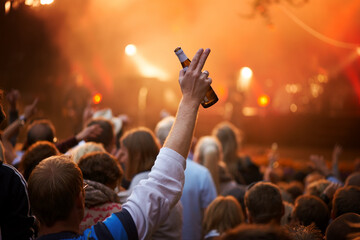 Salute. Rear view of a guy in an audience saluting the band on stage at a music festival.