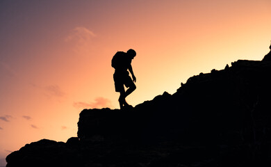 Man hiker climbing up mountain. People taking risk, motivation and outdoor adventure concept.	