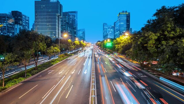 Busy city traffic and modern commercial buildings in Beijing at night, China. Congested city traffic at rush hour. time lapse footage.