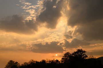 Vanilla sky with cloud and sunlight above trees before sunset, Natural background