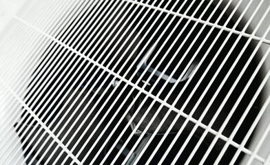 Cooling fan of the outdoor unit. Air conditioning compressor. Ventilation pattern background.