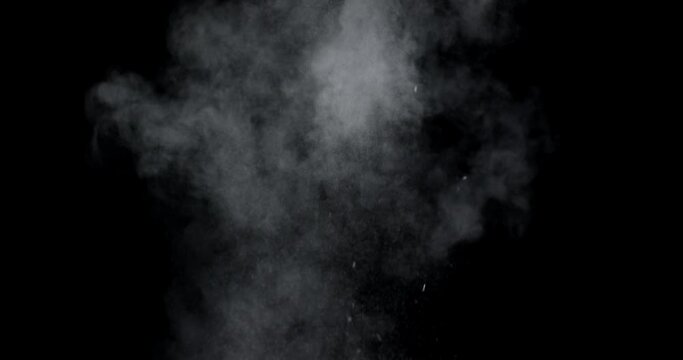 An explosion of dust from the ashes on a black background.