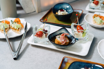 Gourmet bruschetta and profiteroles with plate. Luxury catering, modern food service.