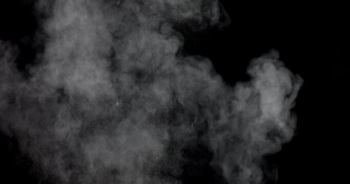 An explosion of dust from the ashes on a black background.