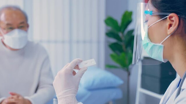 Asian senior male consult with doctor after know the result from ATK.