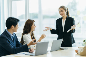 Group of Asian business people team meeting in modern office working design planning and ideas concept