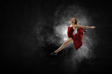 Fototapeta na wymiar Female dancer against abstract colourful background . Mixed media