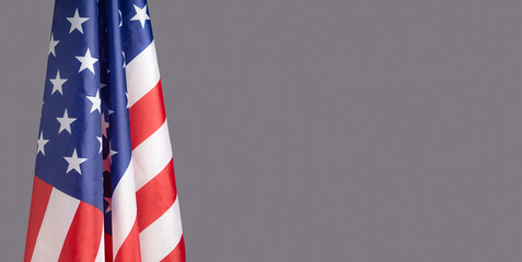 lose-up of the American flag is on the left side on a gray background
