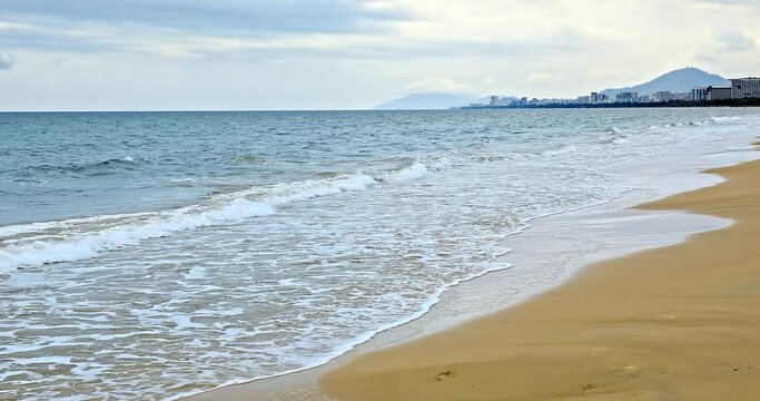 White foam of rolling waves in Sanya, Hainan Island, China. Beautiful seascape. famous resort in china.