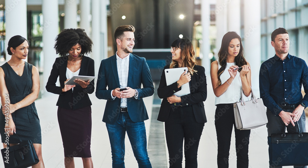 Poster what are we waiting for. shot of a group of confident young businesspeople standing in a row next to