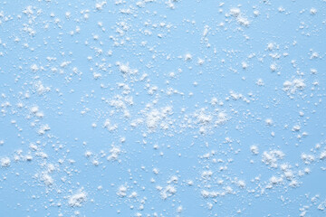 Some flour is sprinkled on a sky blue silicone pad. blue christmas background.