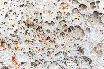 texture of porous stones on the beach, nature, natural phenomena, brown gray stones
