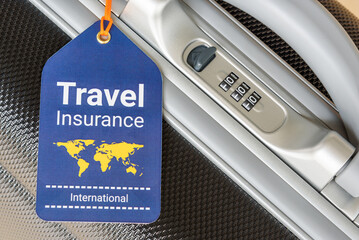 Travel safety and travel insurance concept : Travel insurance tag is hung near a numeric combination lock. Travel insurance is intended to cover lost luggage, trip cancellation, accident, losses, etc - Powered by Adobe