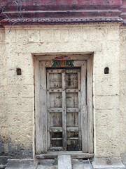 21 March 2022, Pandharpur, India, Old Vintage wooden door on retro wall, Pandharpur, India.