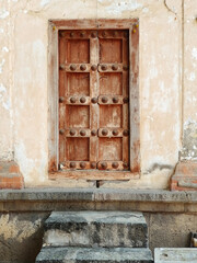 21 March 2022, Pandharpur, India, Old Vintage wooden door on retro wall, Pandharpur, India.
