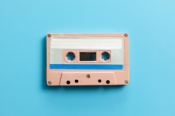 Vintage audio cassette on blue background