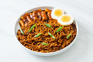 Jjajang Rabokki - Korean instant noodles or Ramyeon with Korean rice cake or Tteokbokki and egg in black bean sauce