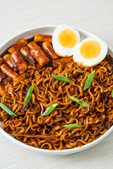 Jjajang Rabokki - Korean instant noodles or Ramyeon with Korean rice cake or Tteokbokki and egg in black bean sauce