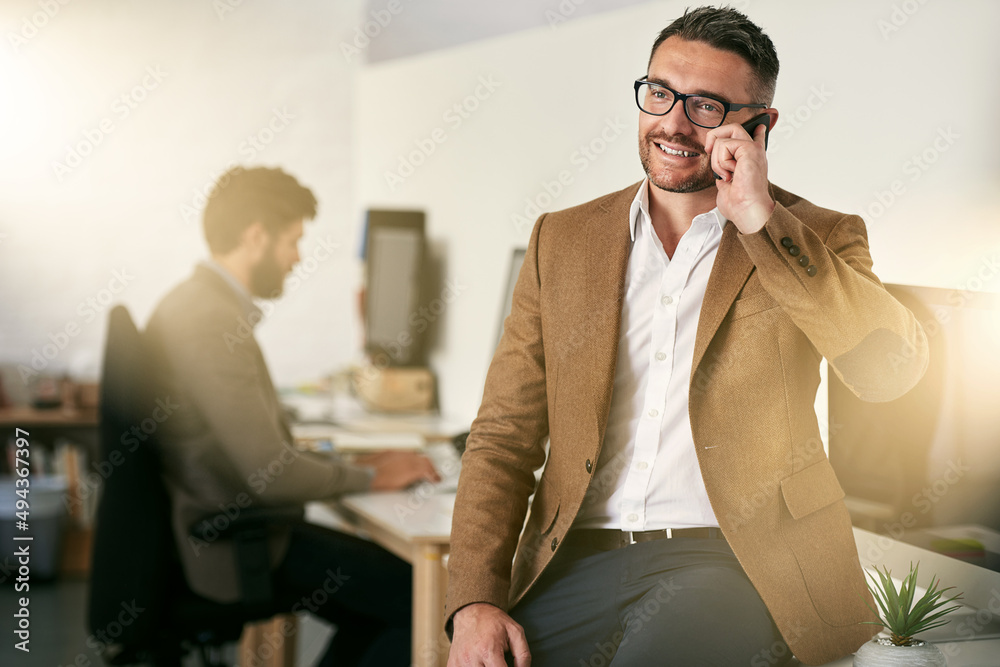 Poster communication works for those who works at it. shot of a man using his cellphone with his colleagues