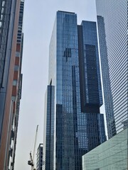 Fototapeta na wymiar Tower crane among high rise buildings in Seoul
