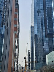 Fototapeta premium Tower crane among high rise buildings in Seoul