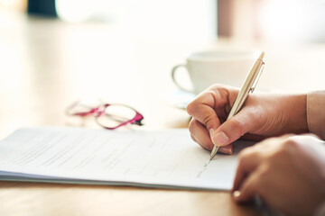 Sign on the dotted line. Cropped shot of an unrecognizable businesswoman filling in paperwork in an...
