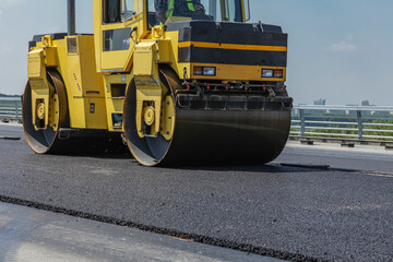 Heavy road construction equipment. Construction of an asphalt road.