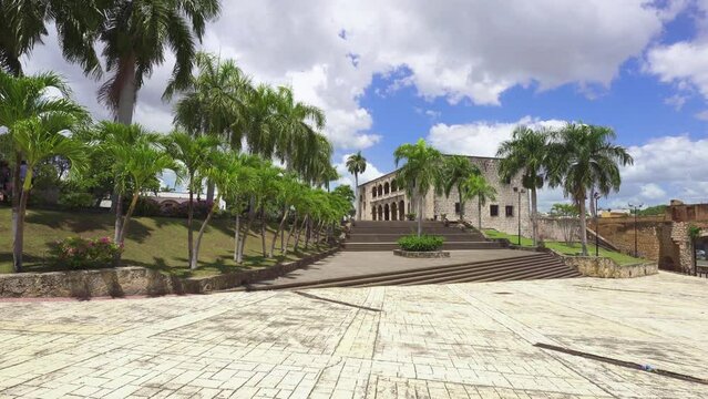 House of the Alcazar de Colon in Santo Domingo in the Dominican Republic. Stone steps and palm trees. Medieval palace in colonial style. Journey through the historical places of the old maritime city.