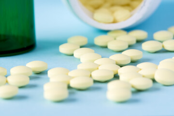 Fototapeta na wymiar Medical pills and tablets spilling out of a drug bottle. Intentional blurred