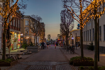 Fototapeta na wymiar Fredericia, DENMARK - 16 December 2021 - Here are people on the pedestrian street, with spruce trees
