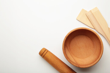 Wooden kitchen utensils on white background.