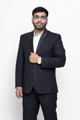 young elegant model wearing suit and eyewear looking at camera on isolated background.
