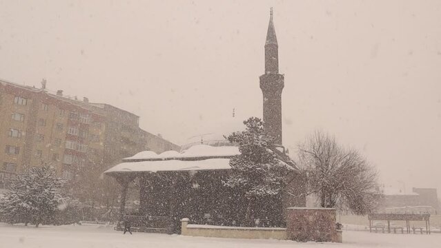 Erzurum in Turkey during a snow storm.
Snow and ice on the mosque (Turkish: Narmanlı Camii)
cold weather in winter, blizzard.
Snowfall on the old building.
freeze, freezing, frozen, ice