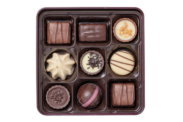 Closeup of box of fine chocolate candies in a beautiful plastic box isolated on a white background. Surprise gift for Valentine's Day or other festive occasions. Macro.
